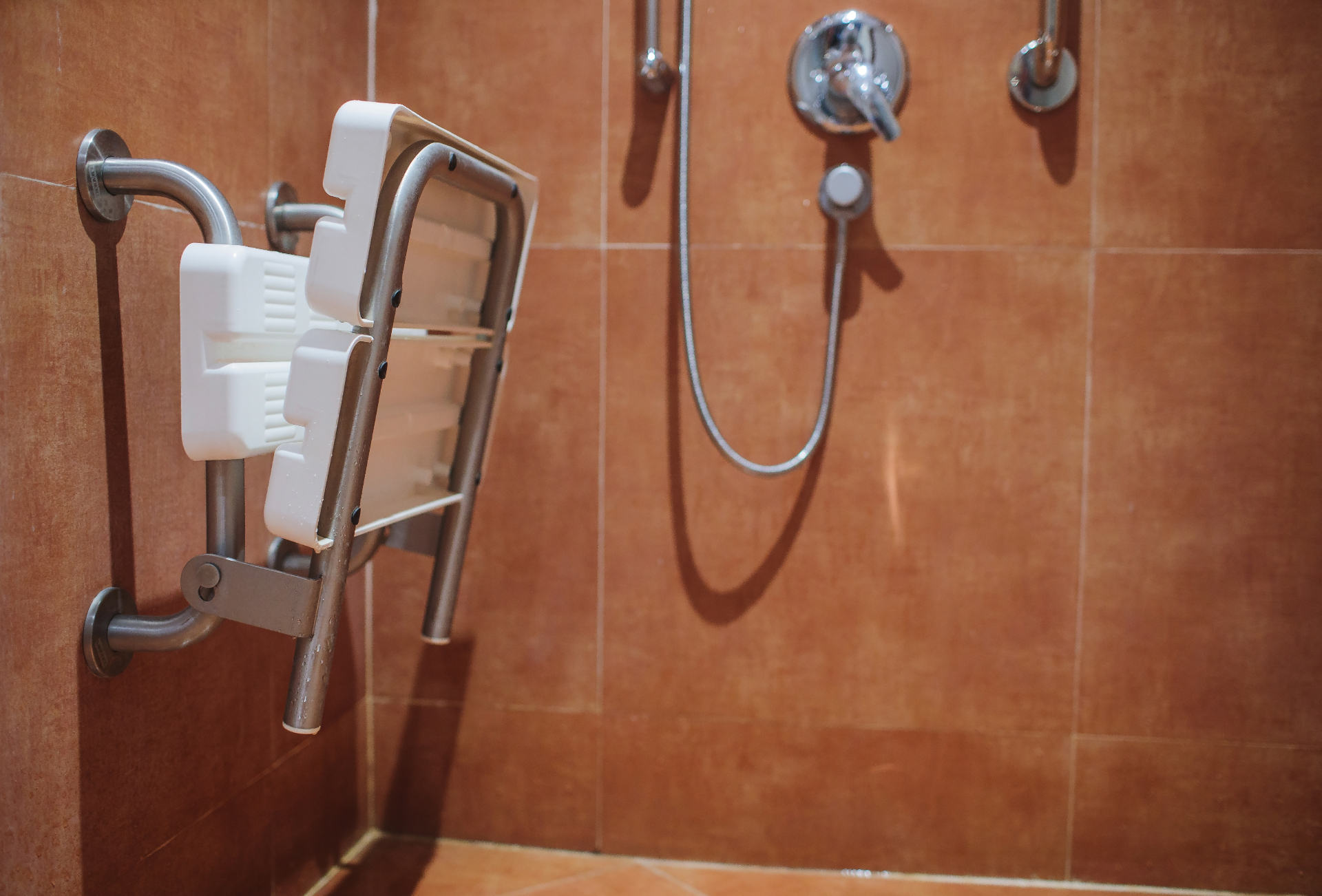 Walk-in shower with fold-down seat and grab bars