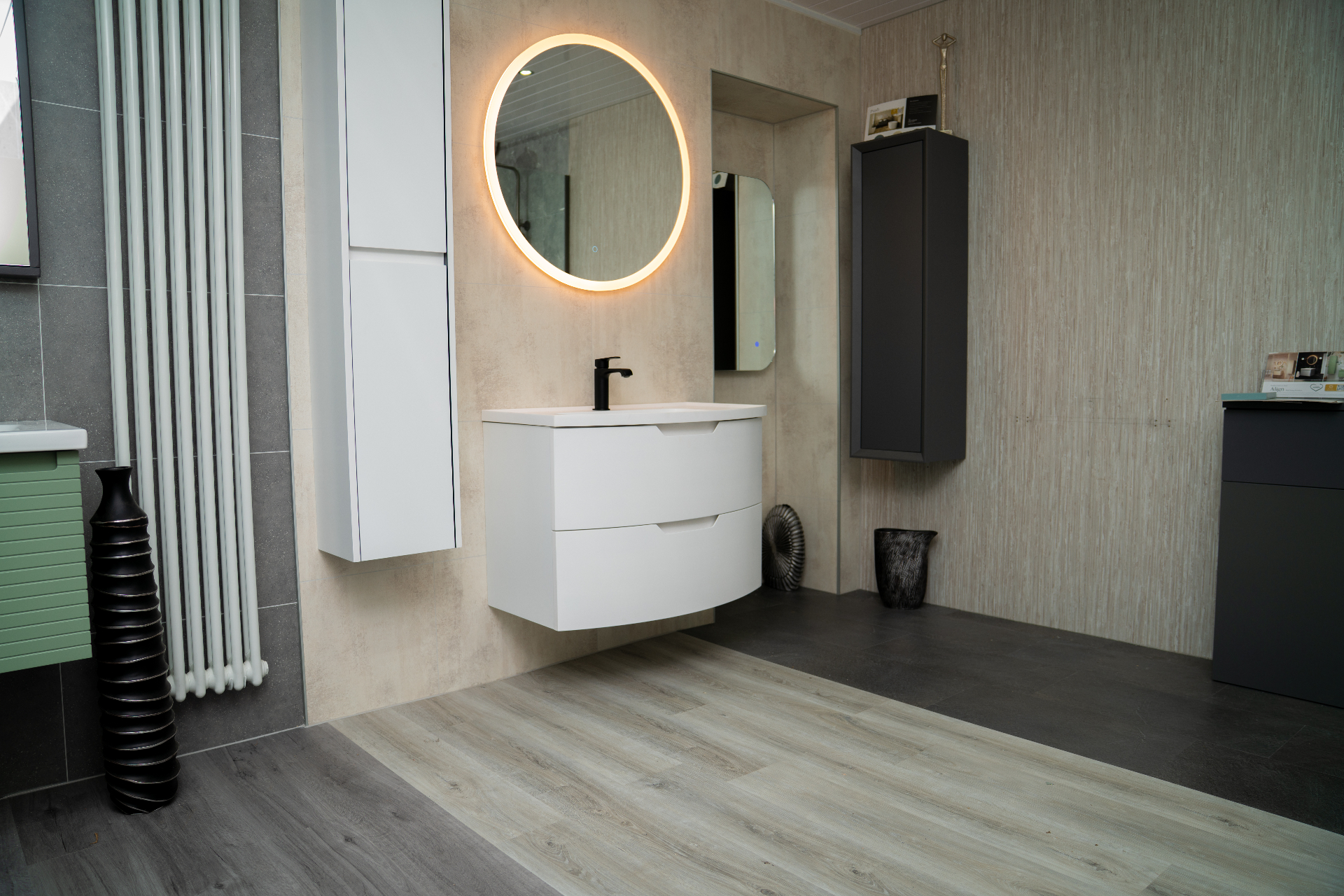 Curved white vanity with backlit mirror in the George Murphy & Son showroom